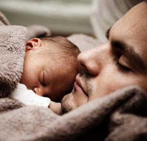 Baby and father sleeping